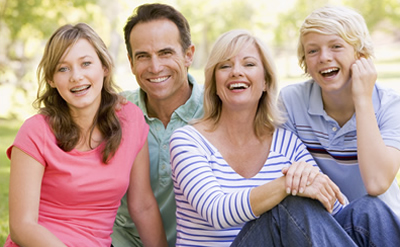 family of four laughing